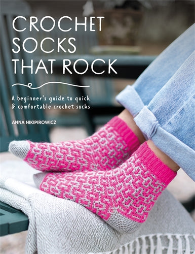 Book cover of 'Crochet Socks That Rock' by Anna Nikipirowicz with pink crochet socks on a blurred background. Yummy Yarn and co stockist Australia